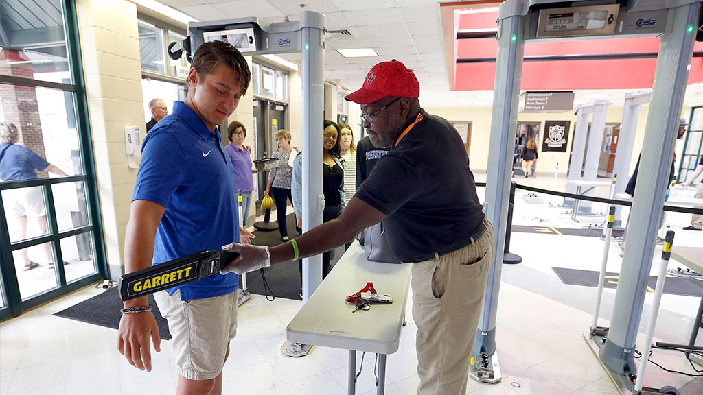 A student being scanned by a metal detector