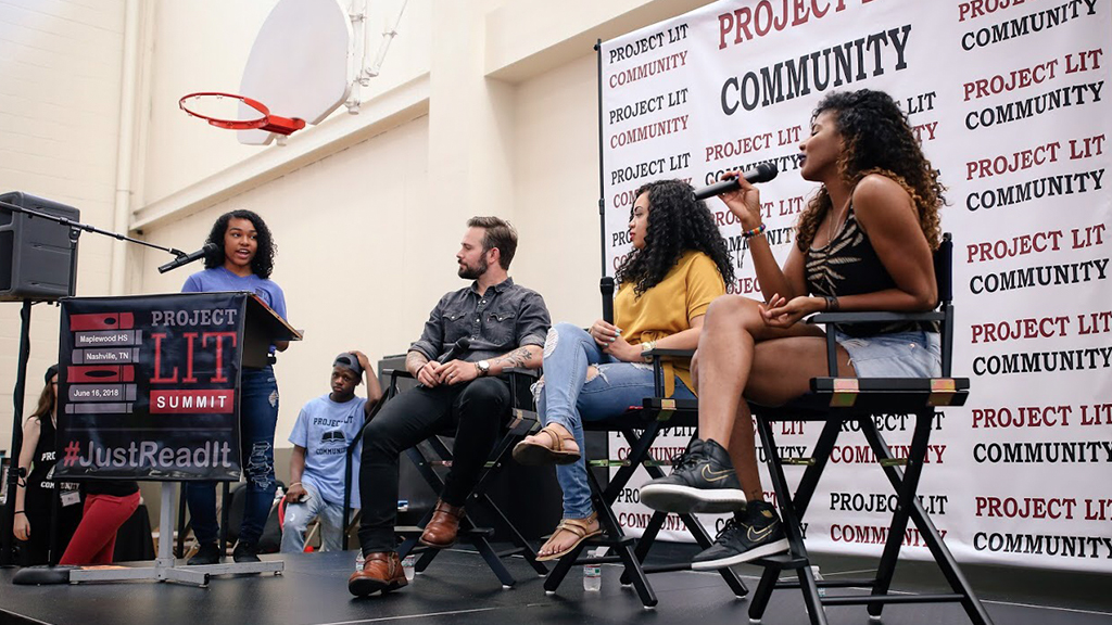 Three panelists and a moderator on a stage