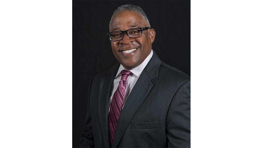 rodney jordan smiles at the camera in a portrait photograph