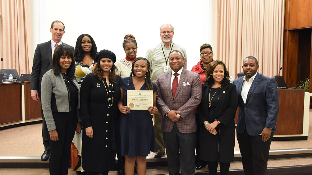 a group picture of the shelby county school board with a student