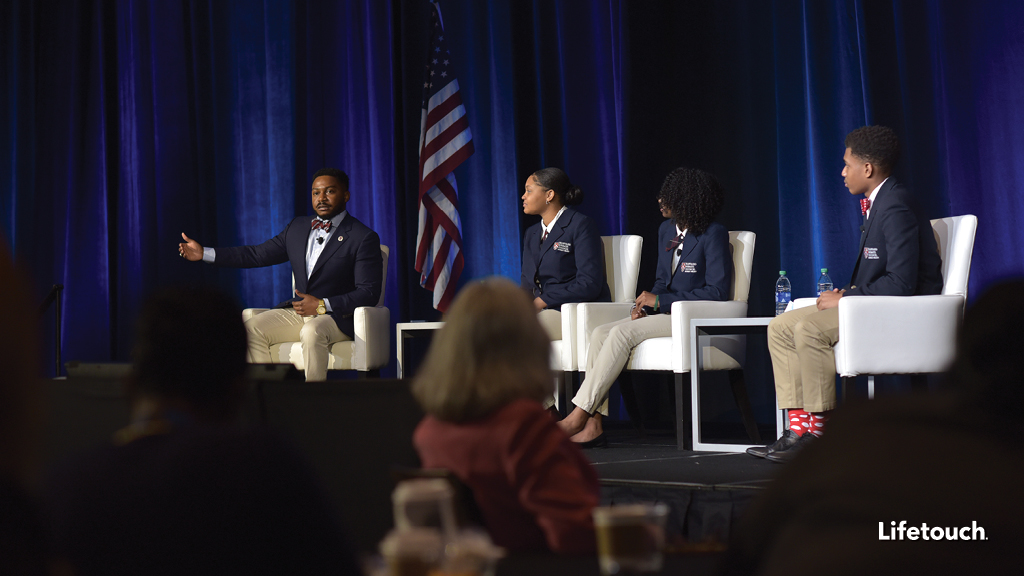 brandon fleming and three students speak on stage