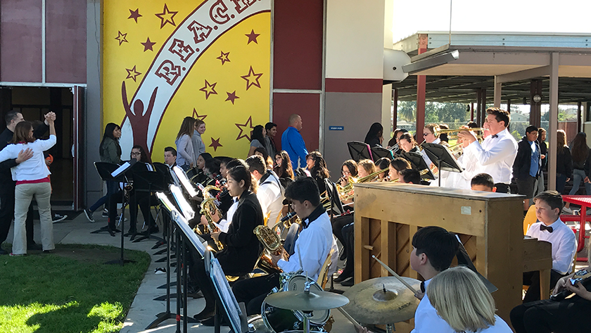 Students play instruments during an outdoor concert