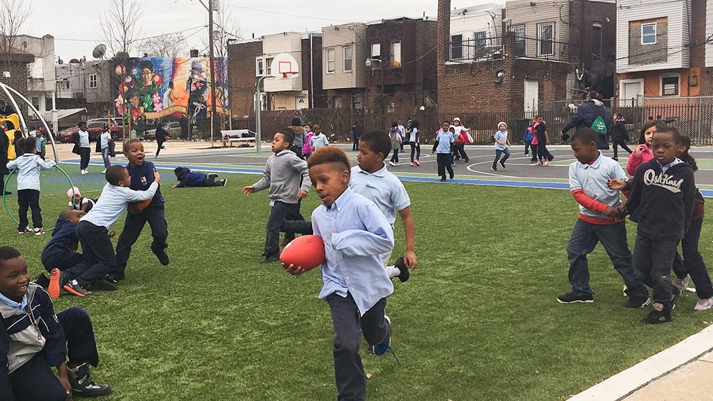 Happy, engaged children play on a safe, redesigned playground in New Jersey