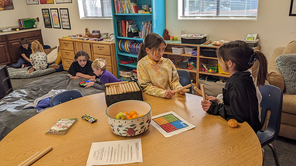 Young students work together in small groups. 