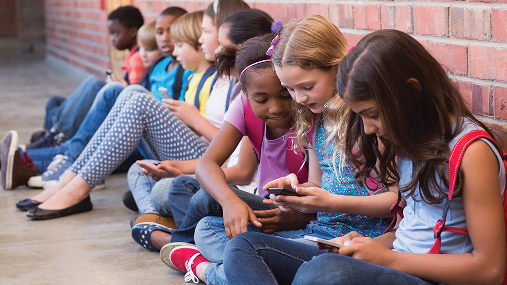 a group of students sit on the floor chatting with one another