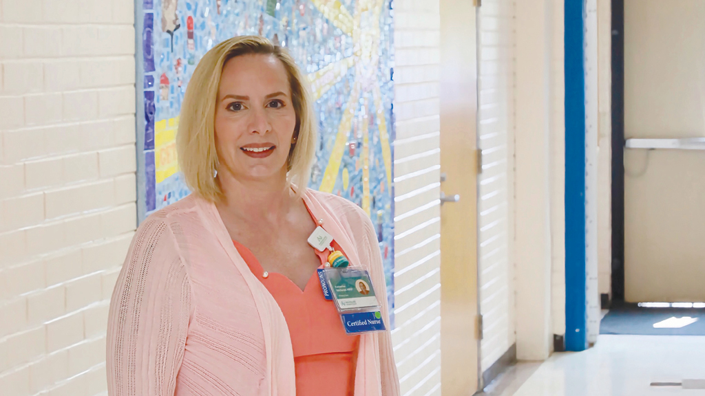 A school nurse poses outside of the wellness room at an elementary school in Delaware.